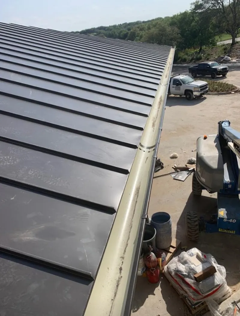 Standing seam panel and gutter detail on a metal roofing jobsite in Washington